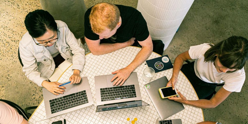 Leadership team charting business goals alongside emerging digital technologies