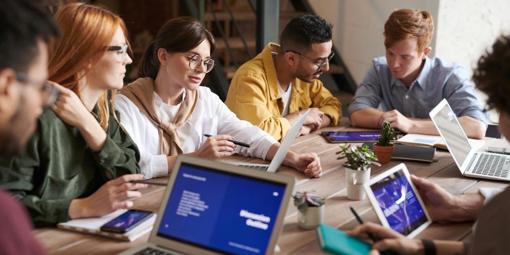 Diverse leaders gathered around a table during a pivotal strategy meeting